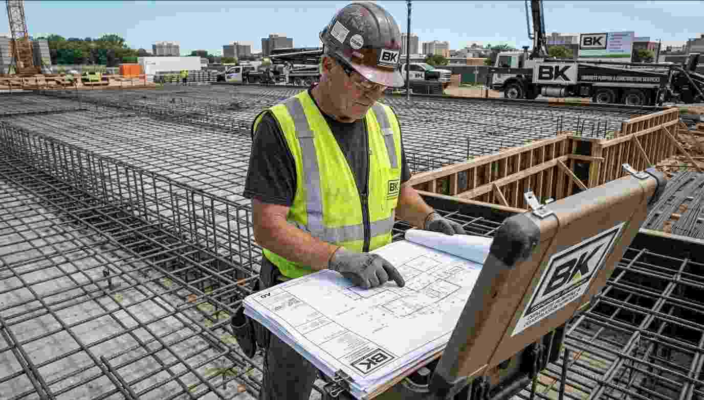 licensed steel fixers Sydney, BK Pumping crew reviewing reinforcement drawings on construction site